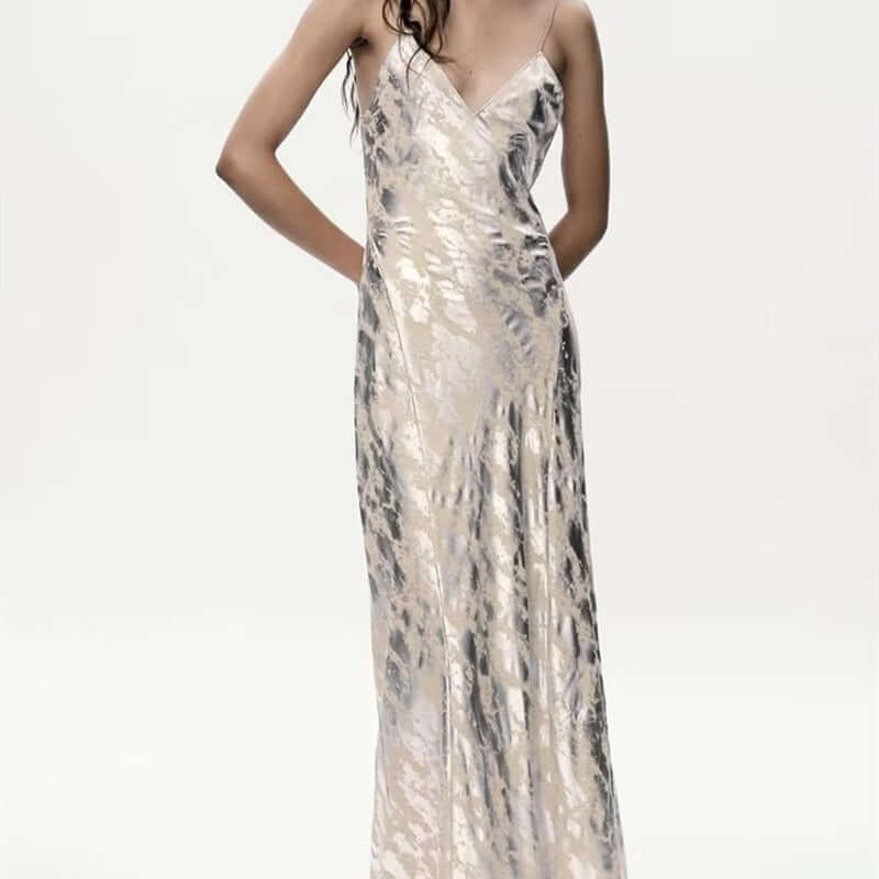 Foil Luxe Dress Foil Luxe Dress worn by a model showcasing the high-waisted sleeveless design in a long silk-like fabric.
